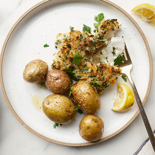 Panko Crusted Baked Cod with a Classic Herb & Dijon Marinade with potatoes and lemon