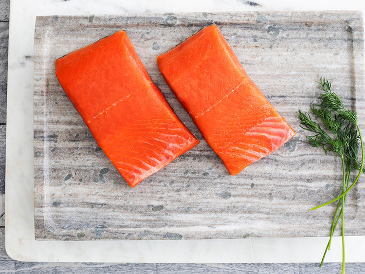 Wild Alaska Coho Salmon Portions on Marble Tray with Herbs