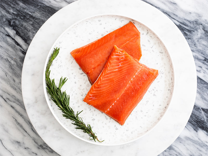 Wild Alaska Sockeye Salmon Portions on Plate with Rosemary Sprig