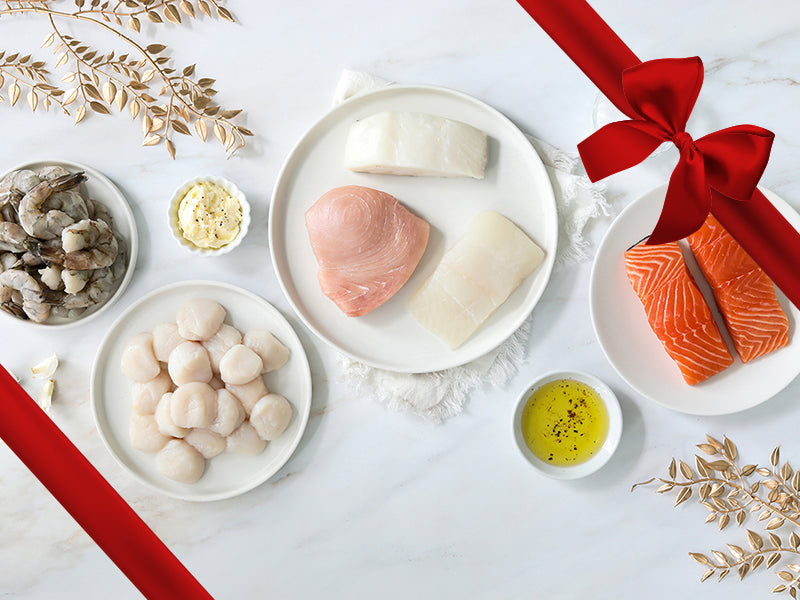 Salmon, Swordfish, Chilean Sea Bass, Halibut, Shrimp, and Scallops on Plates on White Festive Background wtih Gift Ribbon