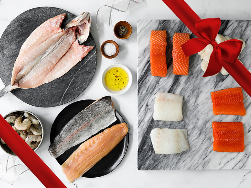 Scallops, Shrimp, Cod, Rainbow Trout, Arctic Char, Salmon, and Butterflied Branzino on Marble Trays and Plates with Gift Ribbon