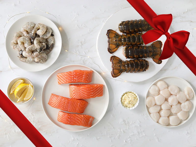 Atlantic Salmon, Scallops, Shrimp, and Lobster Tails on Festive Table with Gift Ribbon