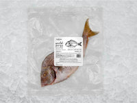 Wild butterflied porgy front of package on ice