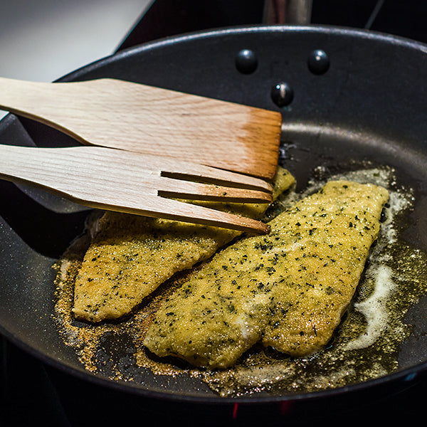 Sole Meunière in pan with wooden utensils