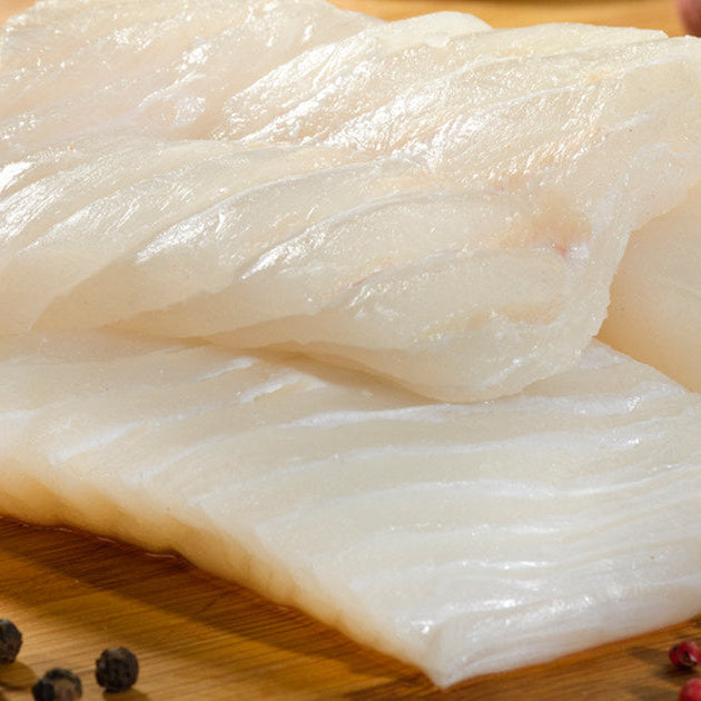 Halibut Portions on Wooden Surface with Peppercorns