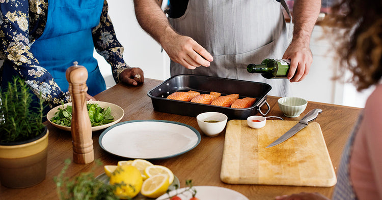 Person Preparing Salmon Portions in a Kitchen