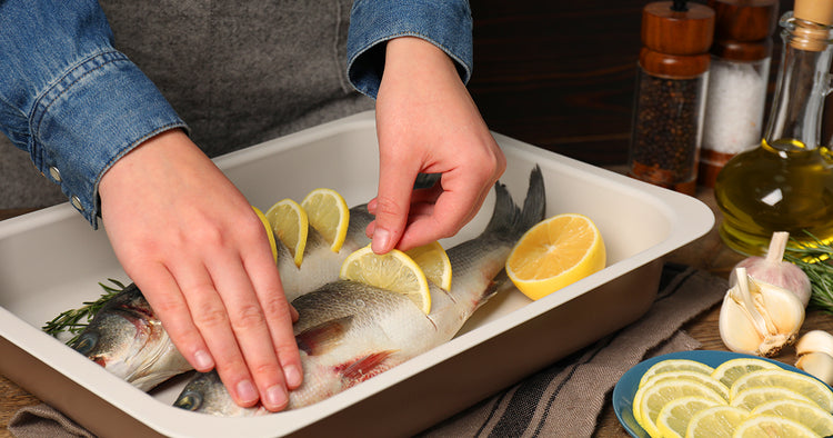 Person Preparing Whole Fish to Cook