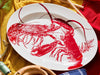 Red Lobsters Oval Rimmed Platter with Small Wood Mallets and Bottle of Wine