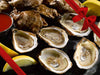 Opened Pink Moon Oysters on Dark Background with Lemon Wedges and Hot Sauce with Gift Bow Graphic on Top Right