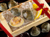 Countneck Clams in Wood Try with Ice and Lemon Slices with Gift Bow Graphic on Top Right