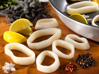 Uncooked calamari rings with lemon and herbs