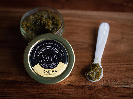 Classic Osetra Caviar on Mother of Pearl Spoon on Wooden Surface