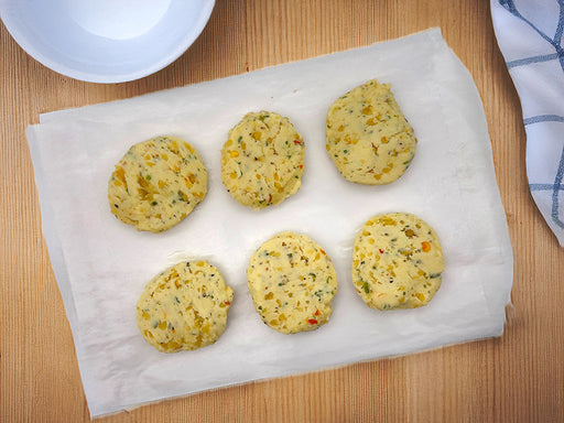 Fulton Fish Market Scampi Finishing Butter - 6ct pucks on white paper on wooden table