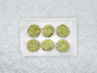 Fulton Fish Market Garlic & Herb Finishing Butter - 6ct pucks on white paper with ice background