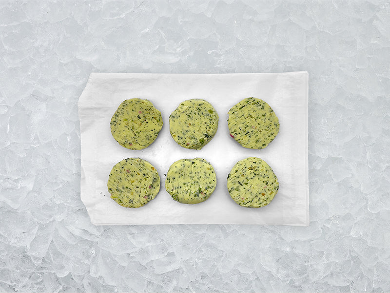 Fulton Fish Market Garlic & Herb Finishing Butter - 6ct pucks on white paper with ice background