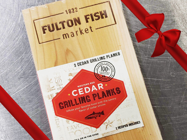 Western Red Cedar Grilling Plank on Steel Surface with Gift Bow Graphic on Top Right