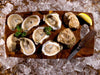 Shucked Pemaquid Oysters with Lemon Wedges, Herbs, and Oyster Knife