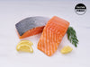 Atlantic Salmon Regular Cut Portions on Marble Surface with Lemon Slices and Herbs