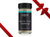 Fulton Fish Market White Fish Seasoning Bottle on White Background with Gift Bow Graphic on Top Right