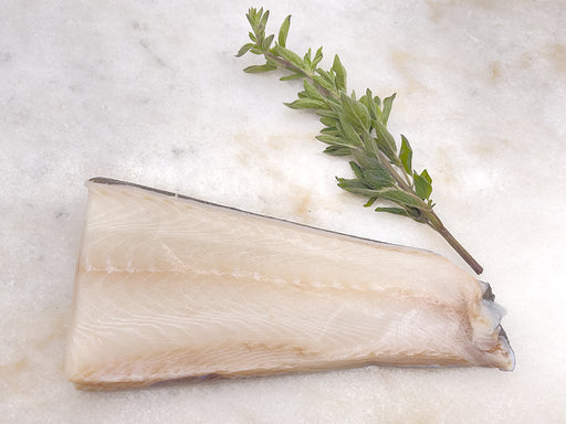 Black Cod Portion on marble with herbs