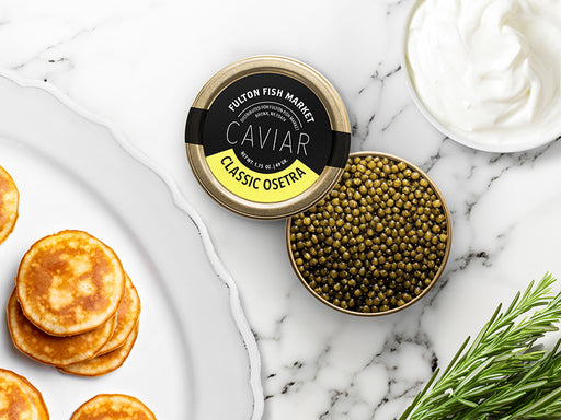 Classic Osetra Caviar Tin Opened on Marble Surface with Creme Fraiche and Blinis