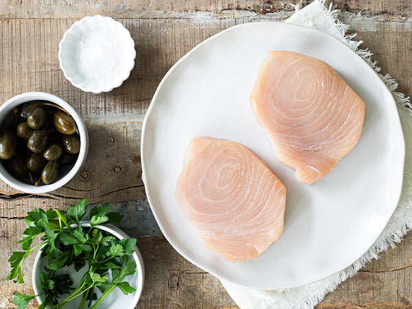 Swordfish Steaks on Plate with Capers, Salt, and Parsley