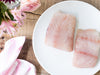 American Red Snapper Portions on Plate on Wood Table with Napkin and Flowers in Vase