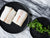 Black Cod Portions on Plate Next to Plate of Microgreens