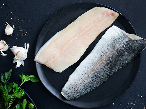 Rainbow Trout Fillets on Plate with Garlic Bulbs and Parsley
