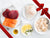 Tuna Steaks, Sea Scallops, Atlantic Halibut Portions, and Atlantic Salmon Portions on Plates on Marble Surface with Gift Bow Graphic on Top Right