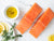 Atlantic Salmon Portions on Marble Surface with Olive Oil, Herbs, and Lemon Slices