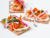 Hot Smoked Steelhead Trout Flaked on Cracker with Onion, Capers, and Dill