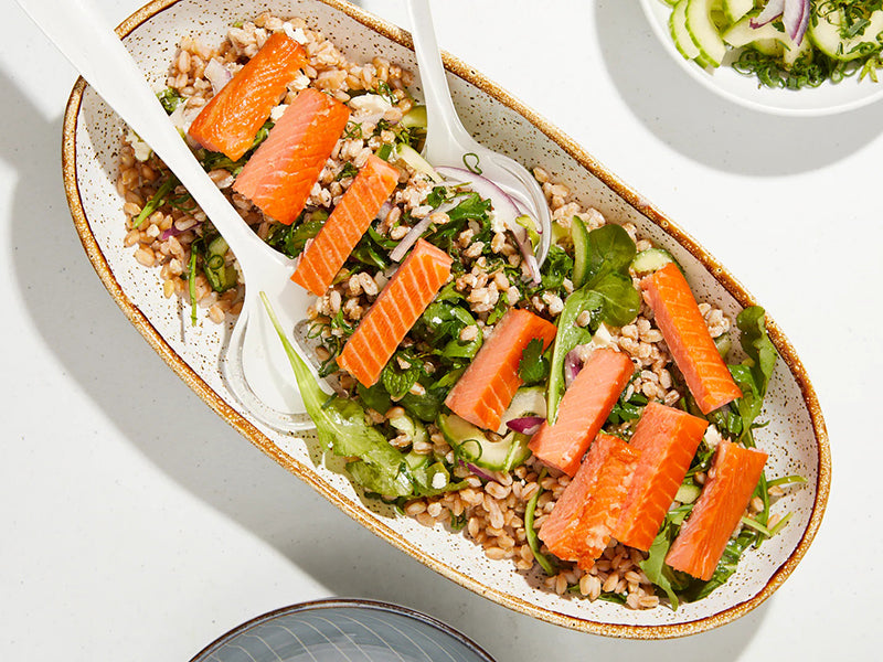 Hot Smoked Steelhead Trout Pieces On Top of Grain Salad in Serving Bowl