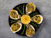 City Pier Oysters Rockefeller on plate with asparagus and lemon