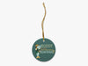 Buddy the Smelt Blue Ornament with Gold String on White Background