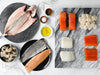 Feast of the Seven Fishes Seafood Assortment on Marble Surfaces and Plates with Gift Ribbons on Table