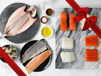 Scallops, Shrimp, Cod, Rainbow Trout, Arctic Char, Salmon, and Butterflied Branzino on Marble Trays and Plates with Gift Ribbon