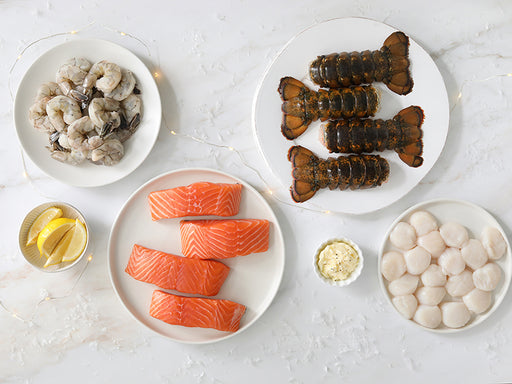 Holiday Dinner Party Bundle with Atlantic Salmon Portions, Scallops, Shrimp, and Lobster Tails on Festive Holiday Background