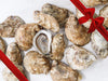 Shucked Pink Moon Oysters on Marble Table with Gift Bow Graphic