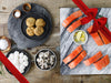 King Salmon Portions, Scallops, Shrimp, and Crab Cakes on Plates with Seasoning and Lemon Wedges with Gift Ribbon