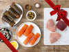 Ahi Tuna Steaks, Swordfish Staks, Salmon Portion, Shrimp, and Lobster Tails on Plates with Gift Ribbon