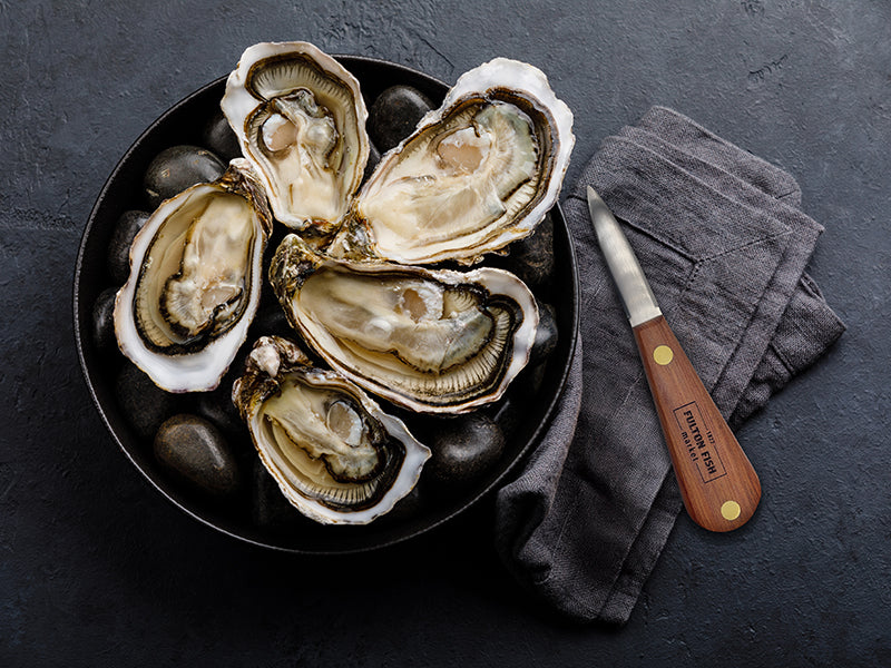 Fulton Fish Market Oyster Knife Next to Bowl of Shucked Oysters on the Half Shell