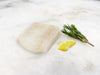 Wild Atlantic Cod Portion on Marble with Lemon and Herbs