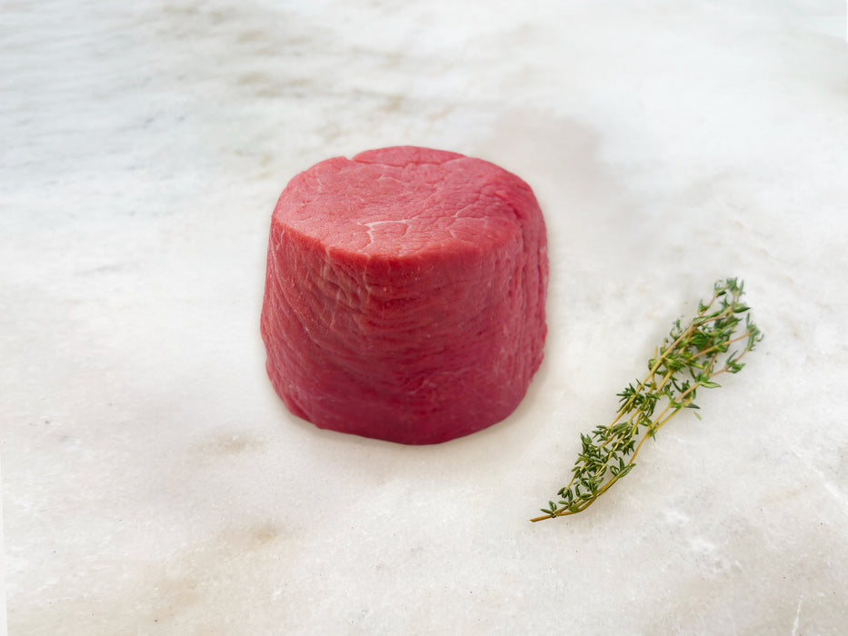 Pat LaFrieda Prime Filet Mignon on Marble Surface with Herbs