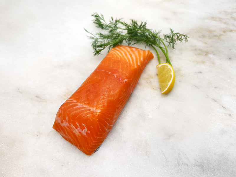 King Salmon Portion on Marble with Lemon and Herbs