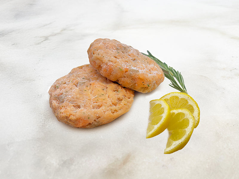 Signature Salmon Burger Patties on Marble with Lemon and Herbs