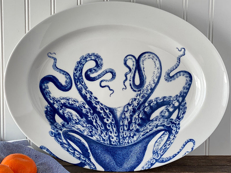 Lucy the Octopus Rimmed Oval Platter Leaning Against a White Panel Wall