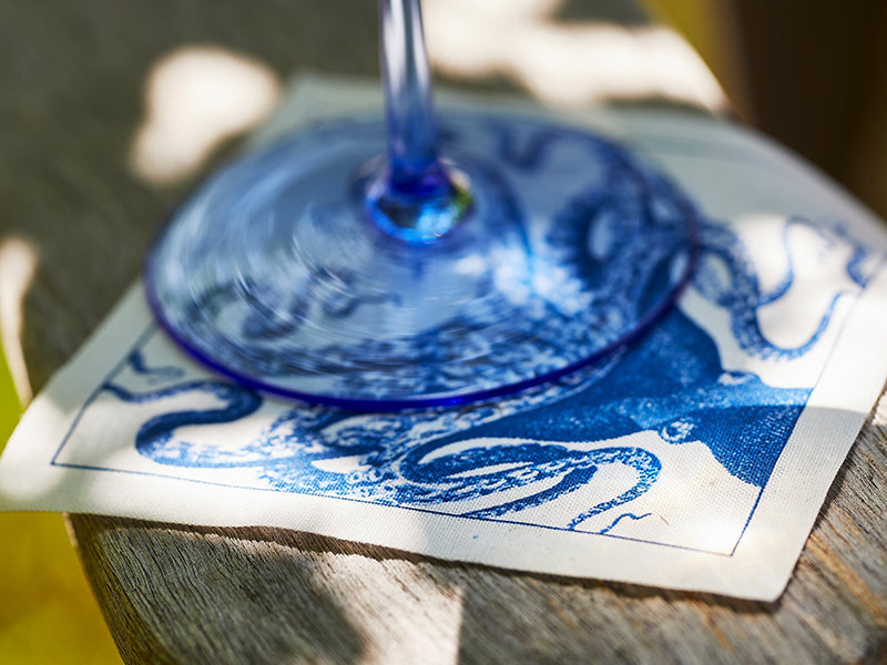 Close Up of Wine Glass On Top of Coastal Cocktail Napkin