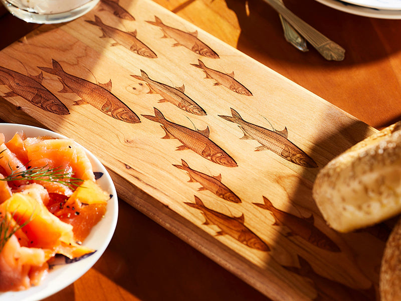 Close up School of Fish Serving Board with Bagels and Smoked Salmon