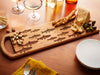 School of Fish Serving Board with Spread of Cheeses, Nuts, and Olives